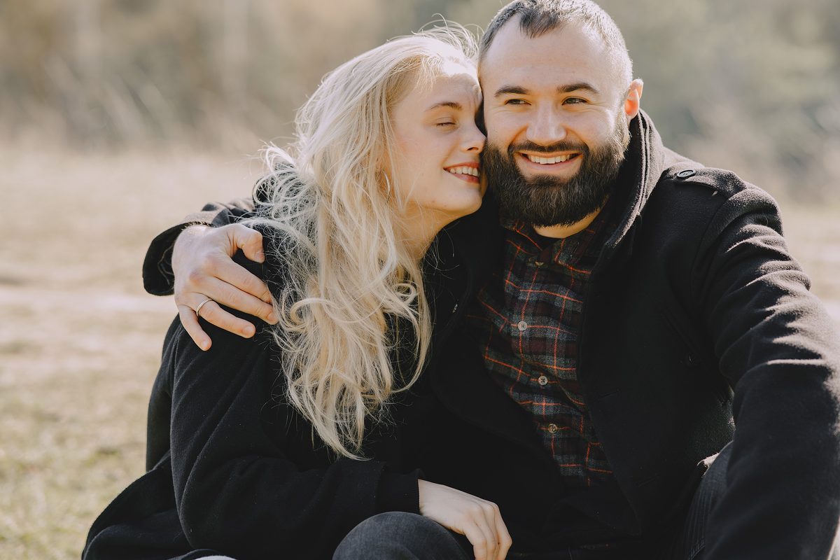Couple outdoors smiling together in coats